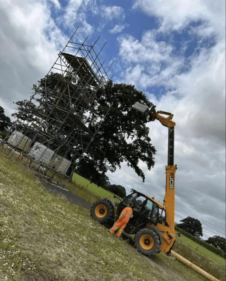 A crane is being used to lift a tree.